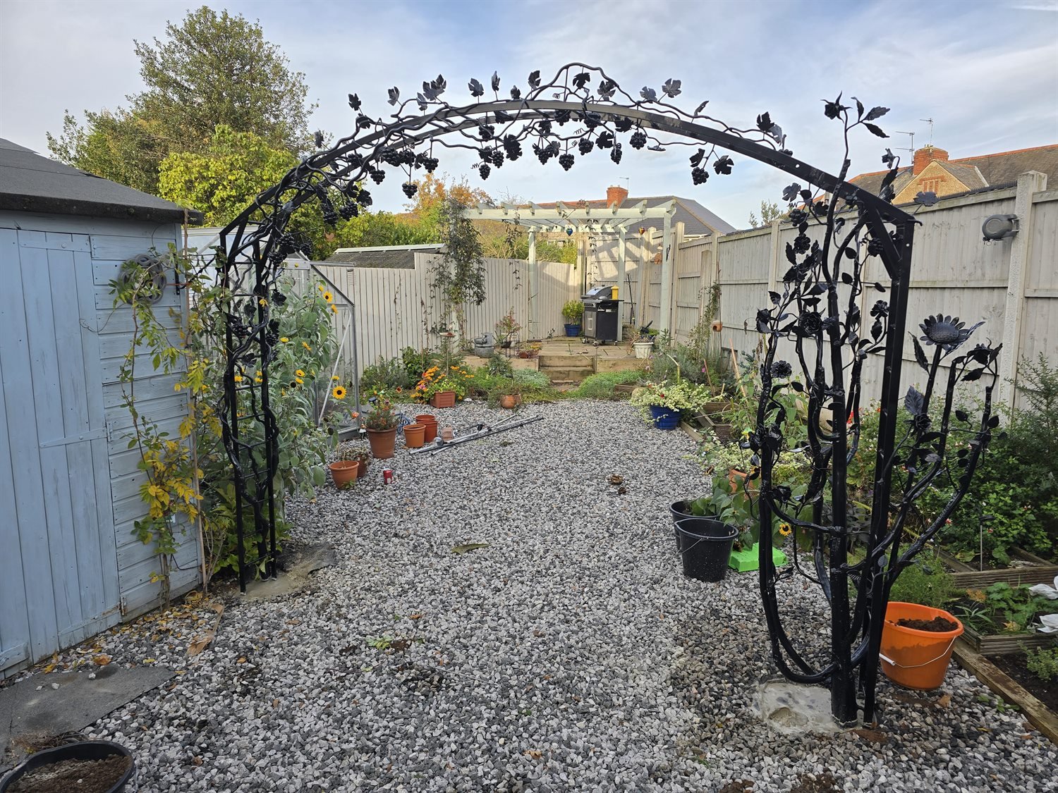 Bespoke steel art grapevine archway fitted in a garden