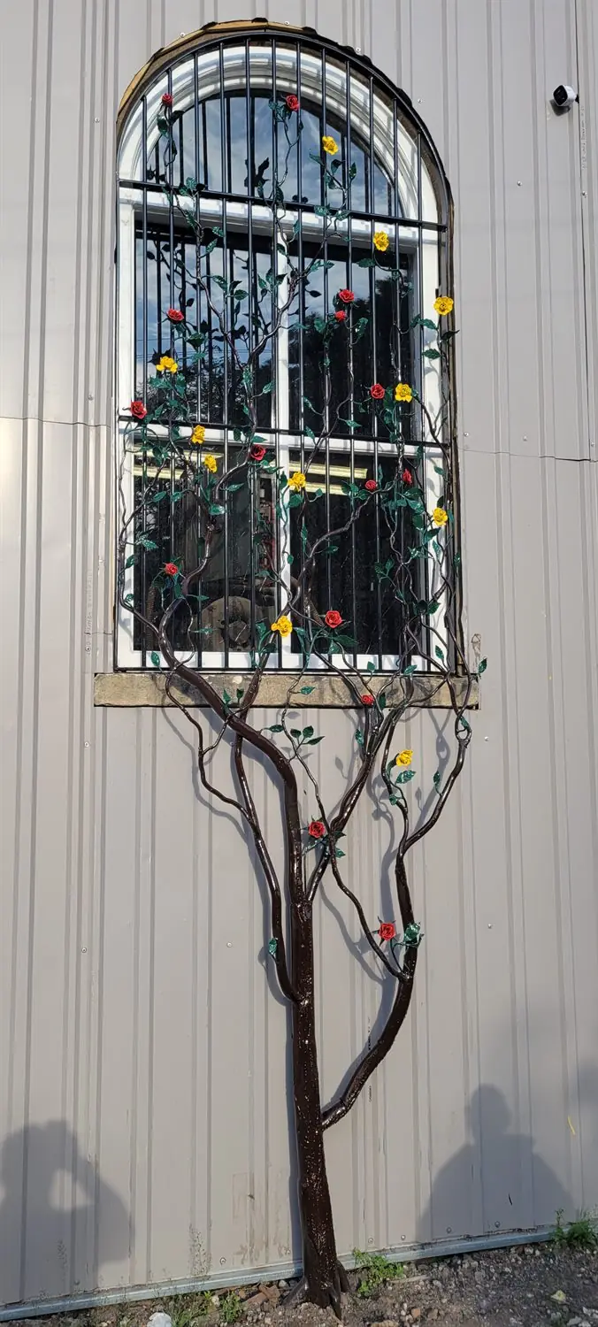Security bars with a bespoke steel tree intertwined through the frame