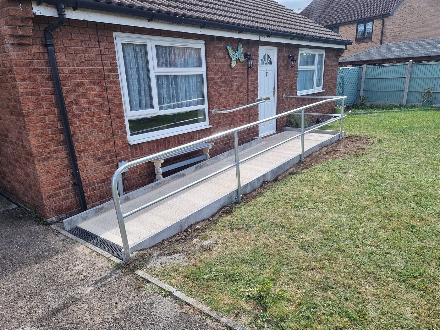 Long metal handrail fitted along a bungalow ramp