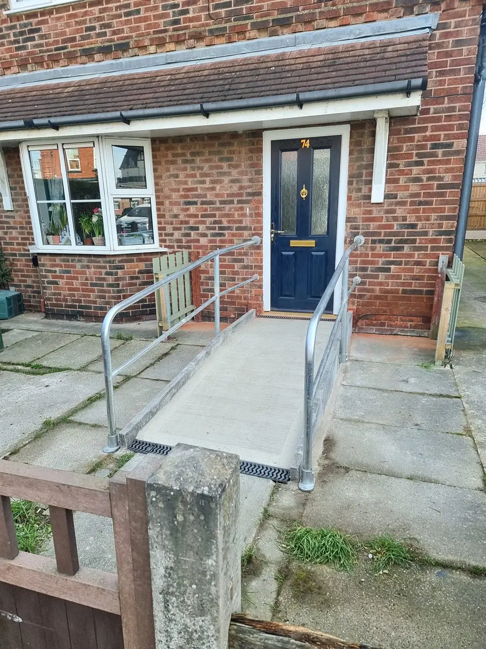Metal handrail fitted beside a stepped entrance