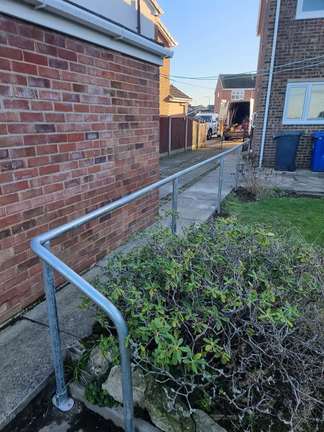Galvanised steel handrail fitted along a narrow access path