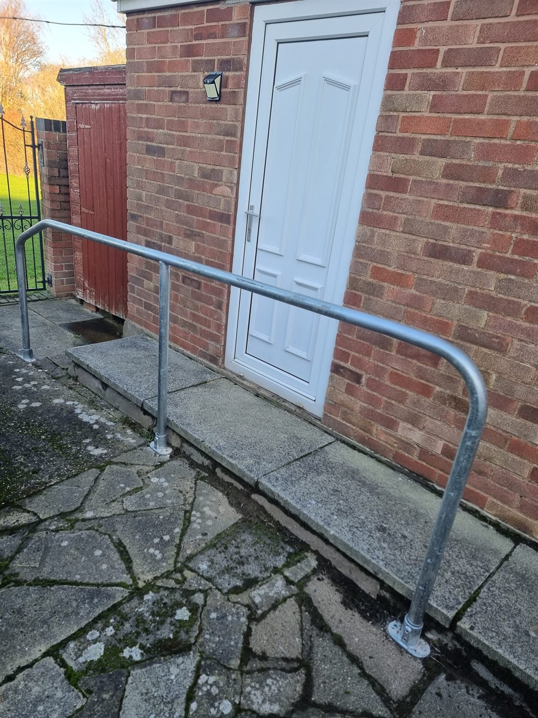 Ramp handrail fitted outside a front door